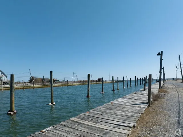 a view of a lake with boats and trees in the background