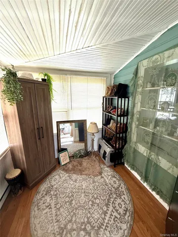 a room with furniture mirror and a window
