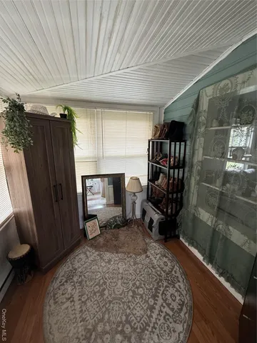 a room with furniture a window and a walk in closet