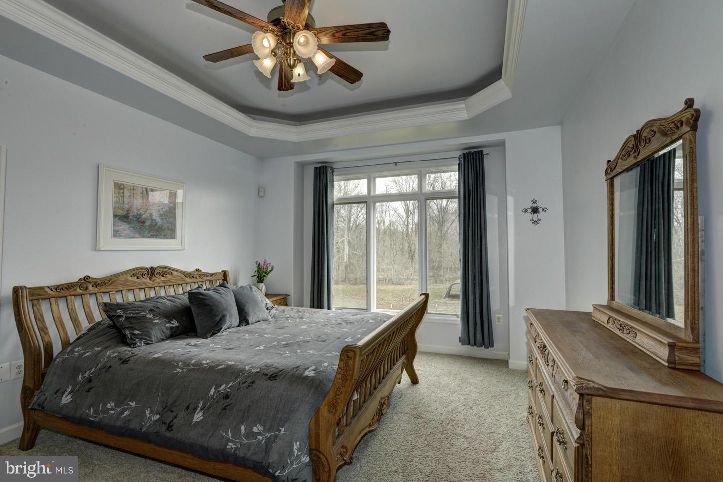 9360 Slate Quarry Road Dickerson, MD 20842 - Photo 14 of 27 a bedroom with a bed and a chandelier
