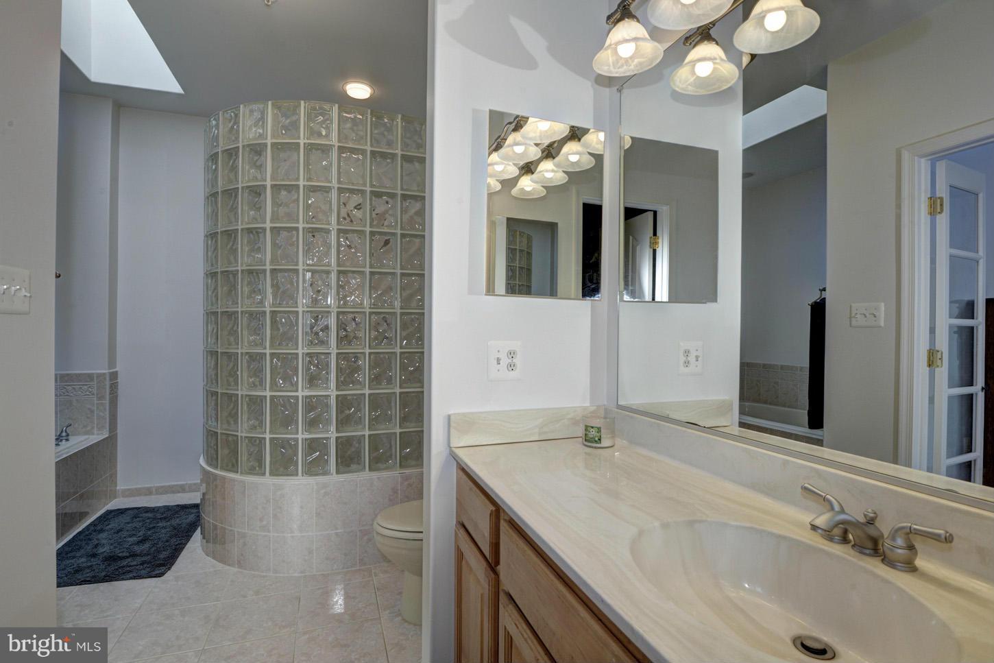 9360 Slate Quarry Road Dickerson, MD 20842 - Photo 15 of 27 a bathroom with a sink a large mirror and a shower