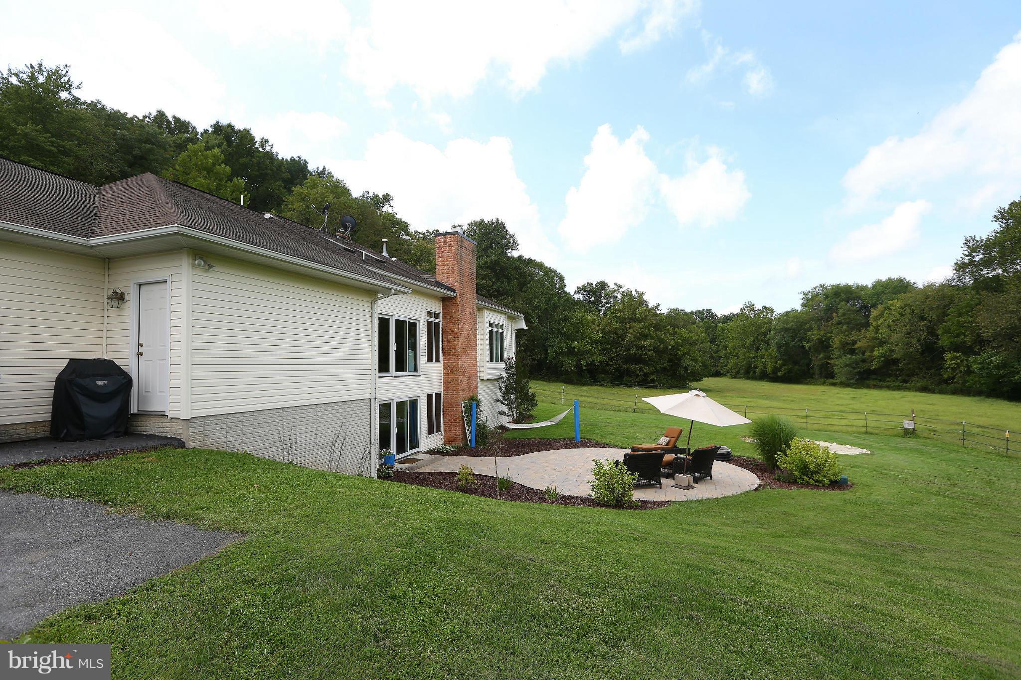 9360 Slate Quarry Road Dickerson, MD 20842 - Photo 23 of 27 a view of backyard with table and chairs and couches