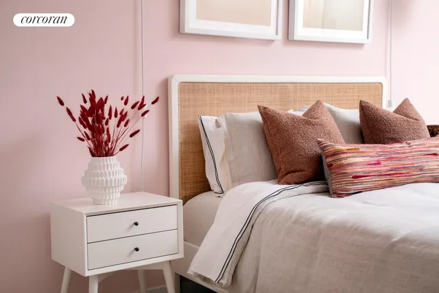 a bedroom with a bed and large windows