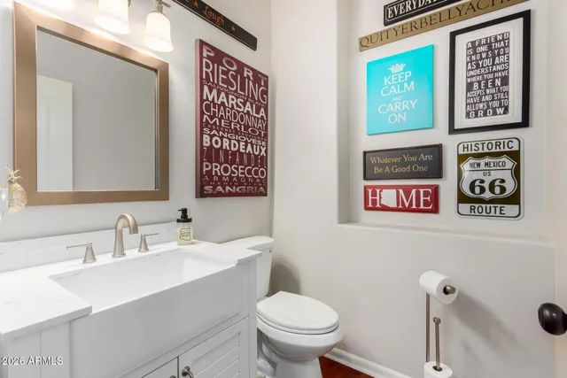 a bathroom with a toilet sink and mirror