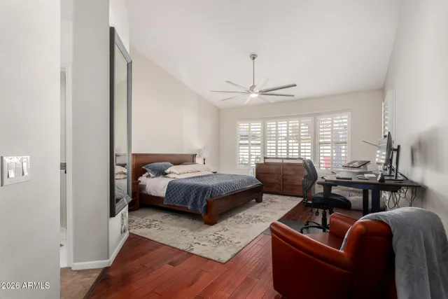 a spacious bedroom with a bed a couch and dresser