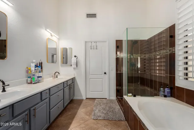 a spacious bathroom with a tub sink and shower