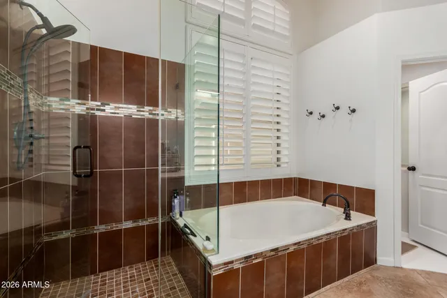 a bathroom with a tub and shower