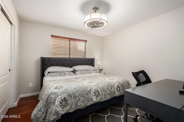 a bedroom with a bed and a chair