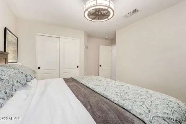 a bathroom with a bathtub shower sink vanity mirror and toilet