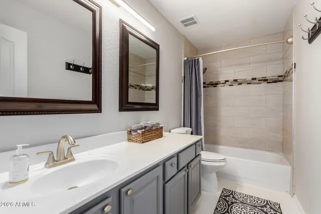 a living room with furniture gym equipment and a rug