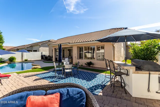 a view of a house with swimming pool and sitting area