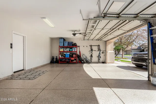 a living room with furniture a flat screen tv and a floor to ceiling window