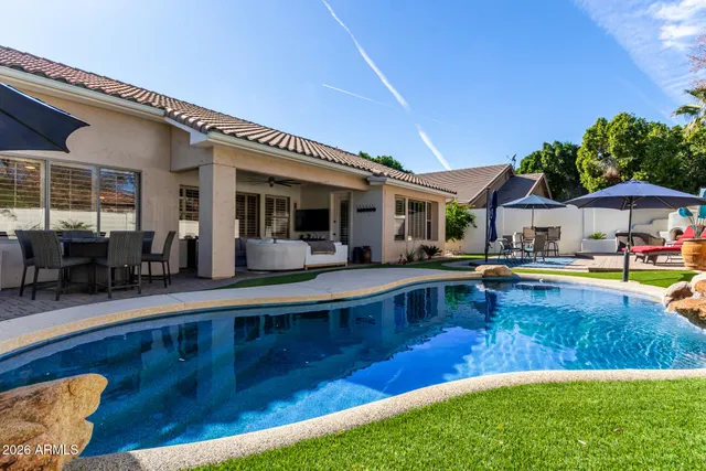 a swimming pool with outdoor seating and yard