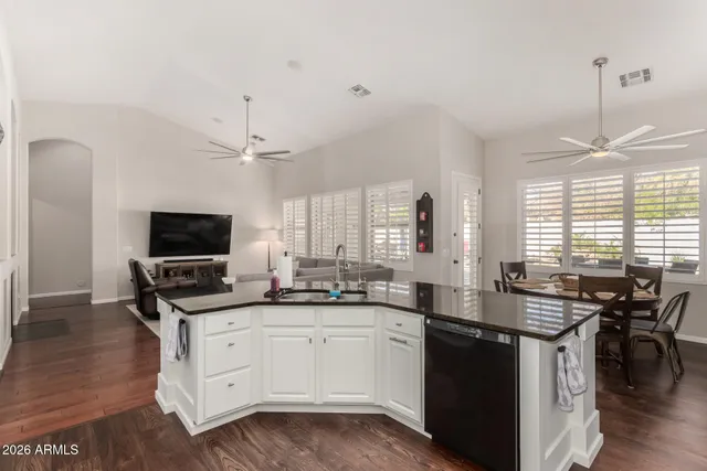 a kitchen with granite countertop a sink and cabinets