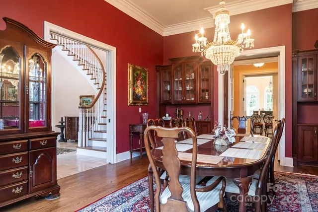 a view of a dining room with furniture and chandelier