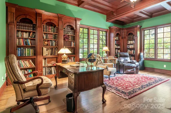 a living room with furniture a rug and a table