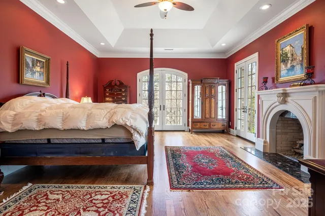 a bed room with a bed mirror and a chandelier