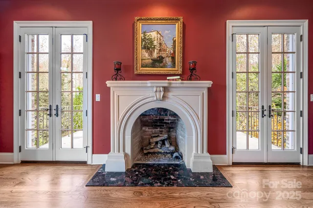 a living room with fireplace windows and wooden floor