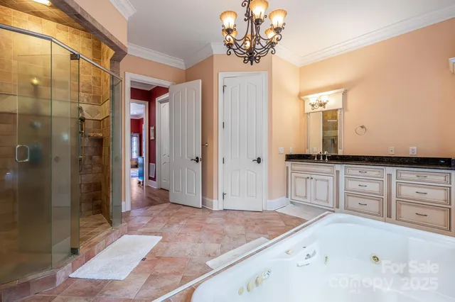 a spacious bathroom with a granite countertop sink a mirror and shower