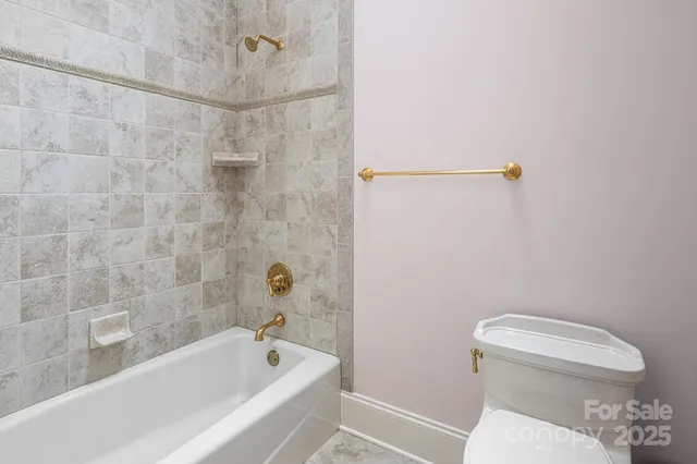 a bathroom with a toilet and a bathtub