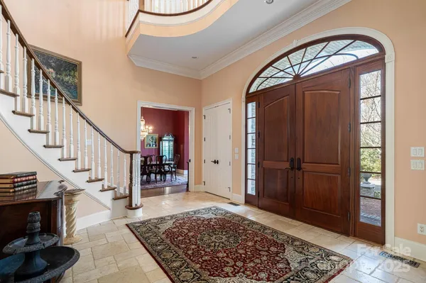 a living room with wooden floor and a rug
