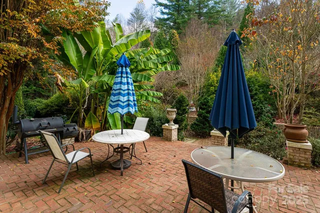 a backyard of a house with table and chairs