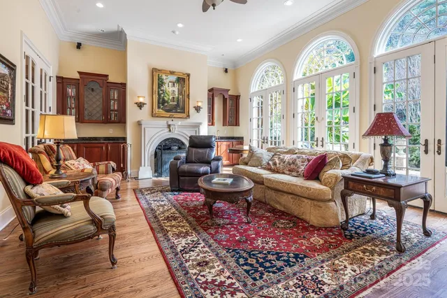 a living room with fireplace furniture and a large window