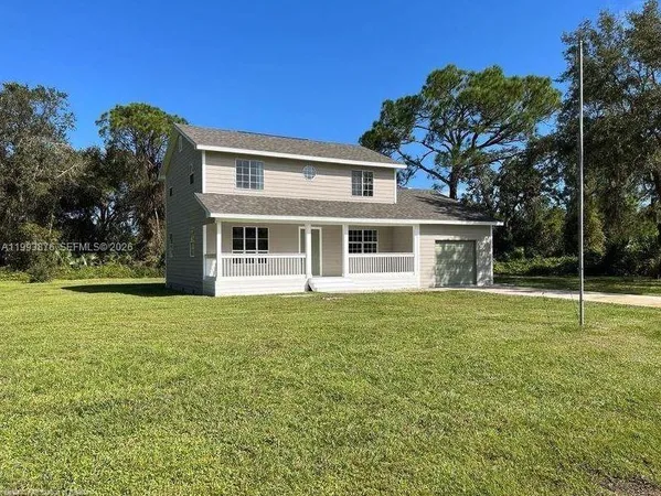 a house with a big yard and large trees