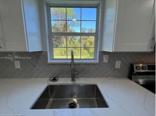 a kitchen with a sink and a window