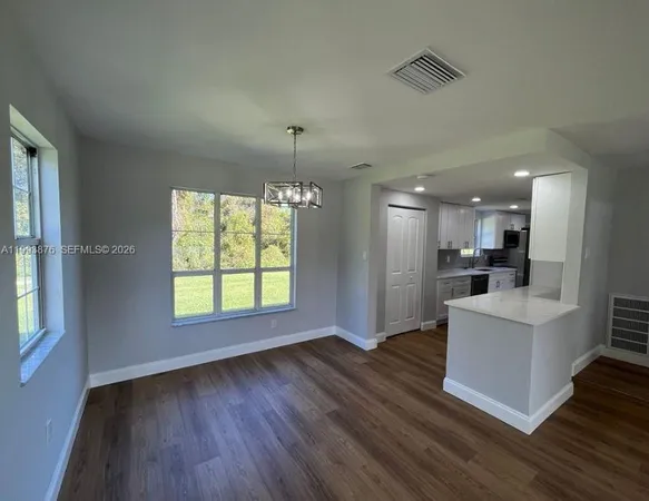 a view of kitchen with cabinets and wooden floor