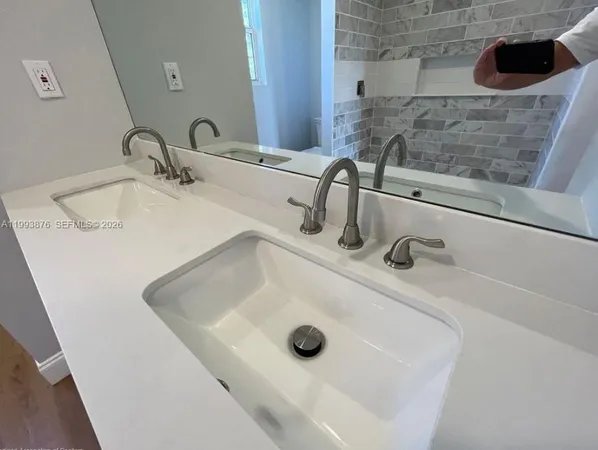 a bathroom with a sink and mirror