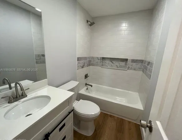 a bathroom with a sink toilet vanity and bathtub