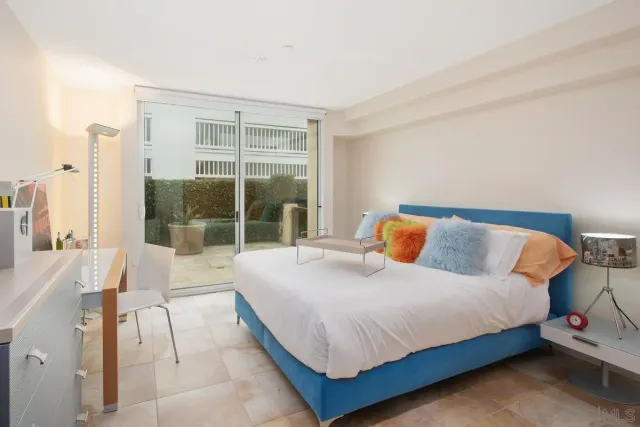 a bedroom with a bed and a large window