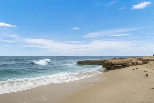 a living room with patio furniture and a large window