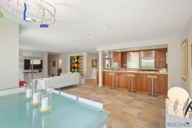 a large white kitchen with a large window