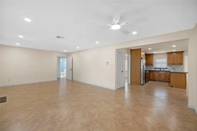 a view of kitchen with kitchen island and stainless steel appliances