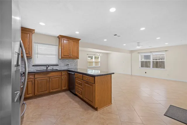 a kitchen with stainless steel appliances granite countertop a sink and cabinets