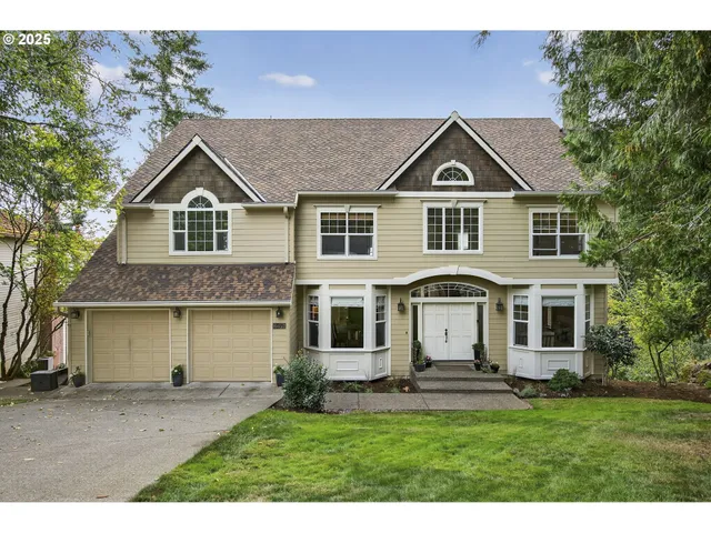 a front view of a house with a yard and garage
