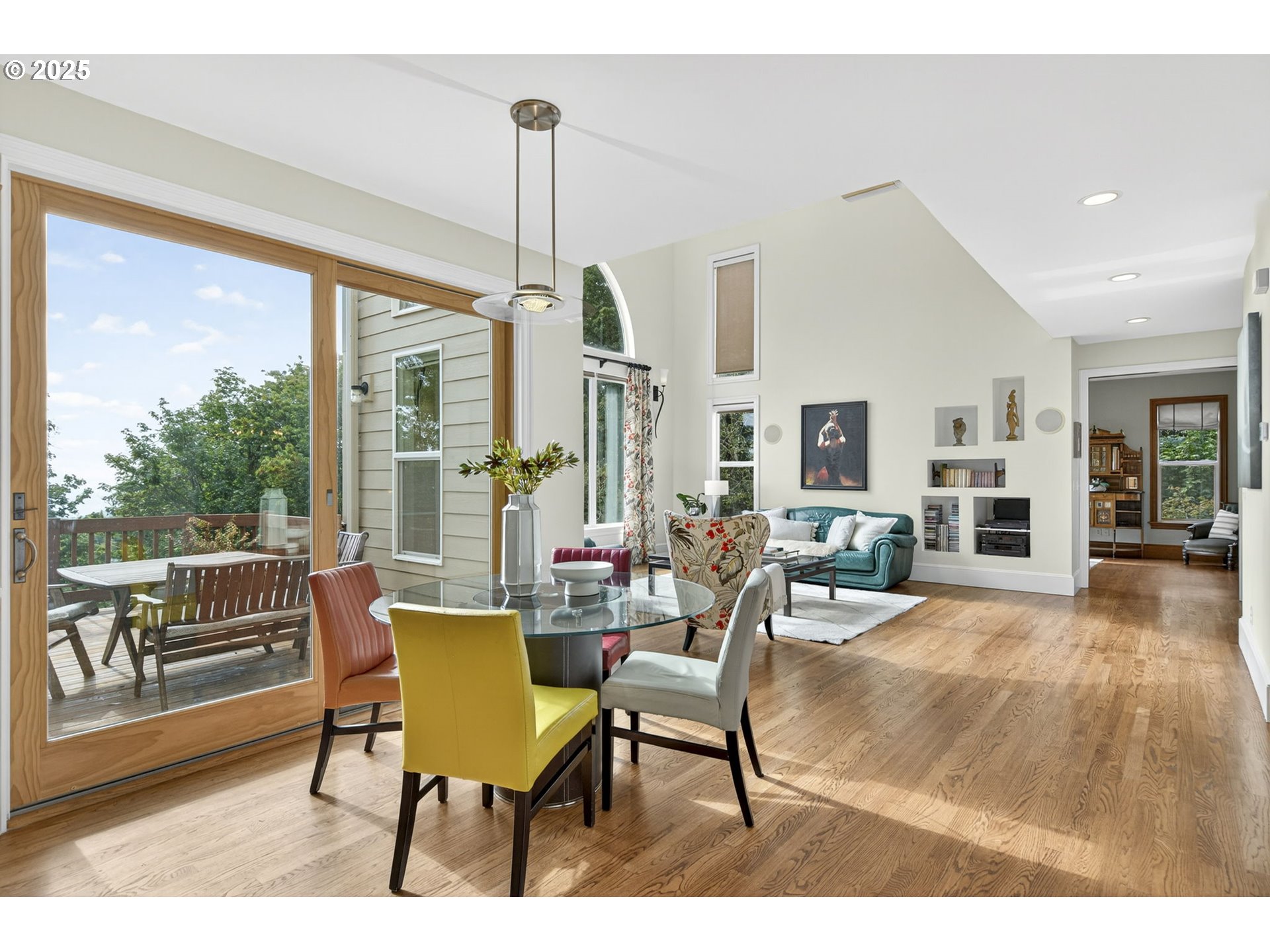 8452 Northwest Timber Ridge Court Portland, OR 97229 - Photo 13 of 48 a view of a dining room and livingroom with furniture wooden floor a chandelier