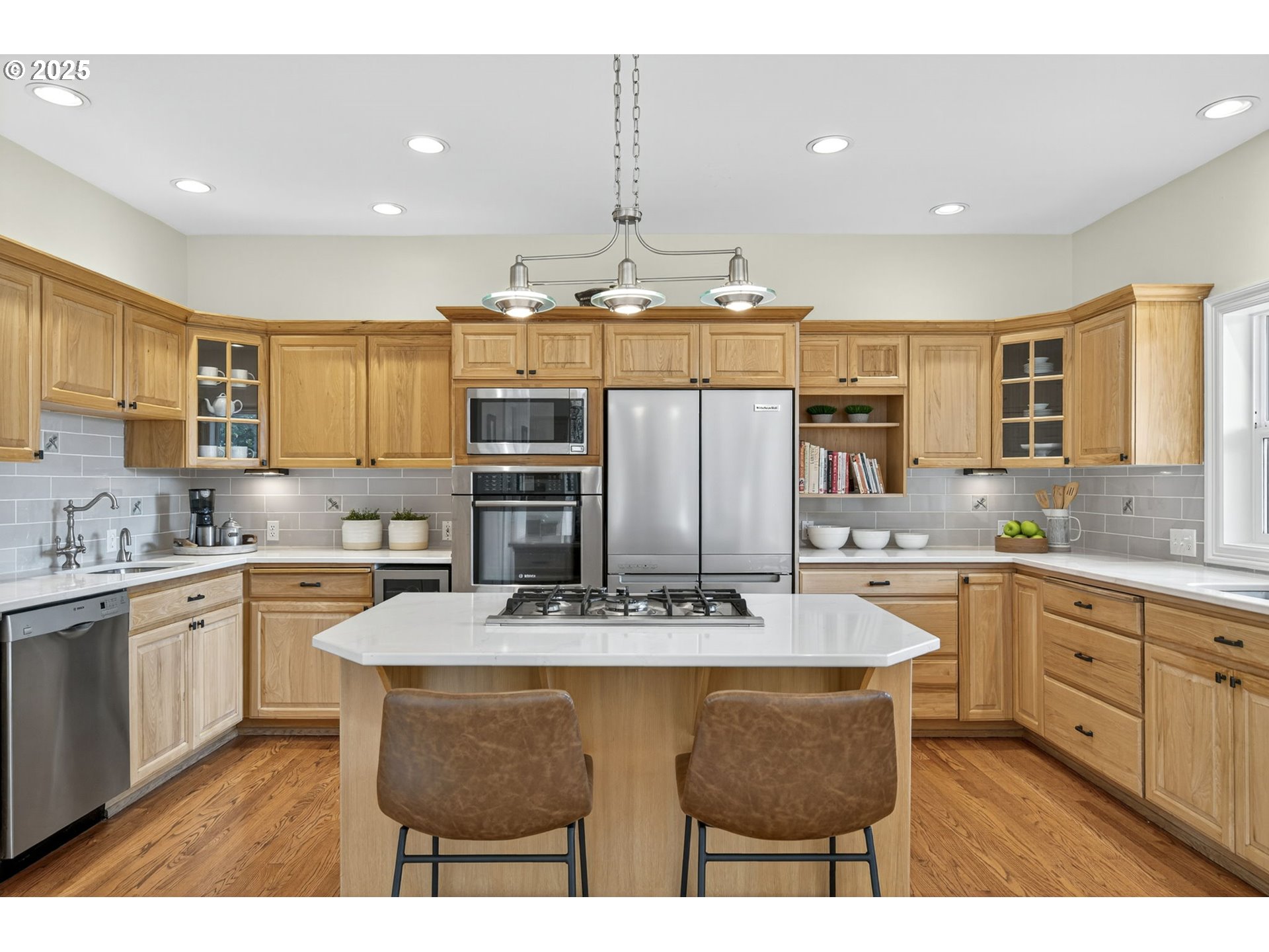 8452 Northwest Timber Ridge Court Portland, OR 97229 - Photo 15 of 48 a kitchen with stainless steel appliances granite countertop a sink a stove a refrigerator a center island and cabinets