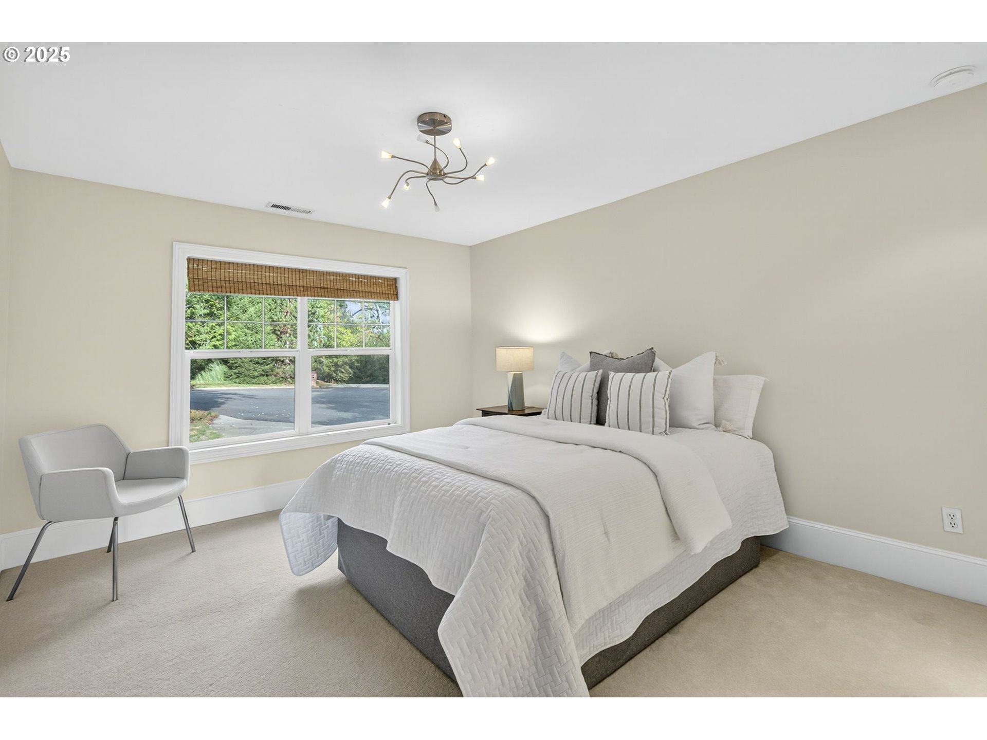 8452 Northwest Timber Ridge Court Portland, OR 97229 - Photo 31 of 48 a bedroom with a large bed and a chair