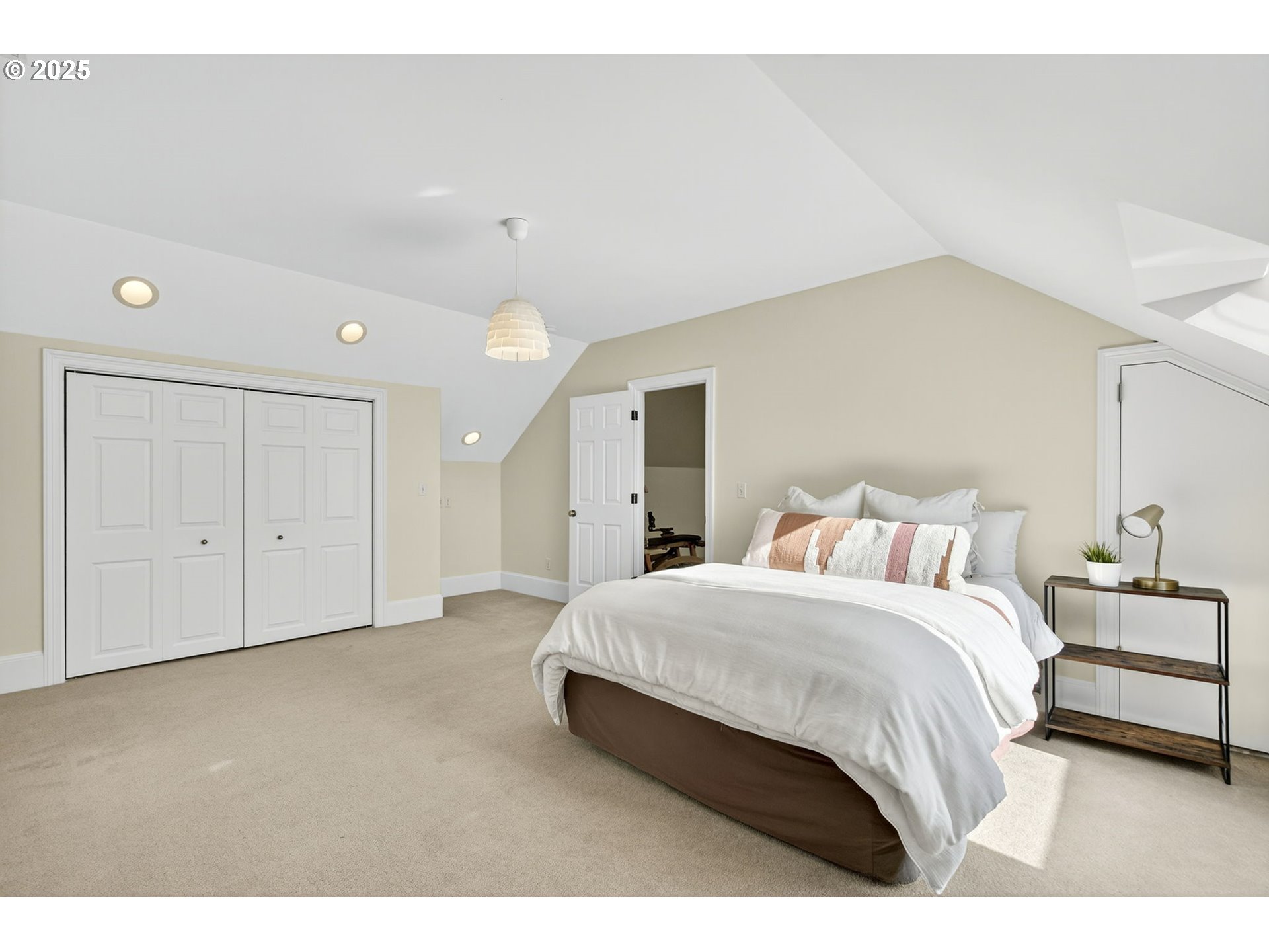 8452 Northwest Timber Ridge Court Portland, OR 97229 - Photo 39 of 48 a spacious bedroom with a bed and a lamp