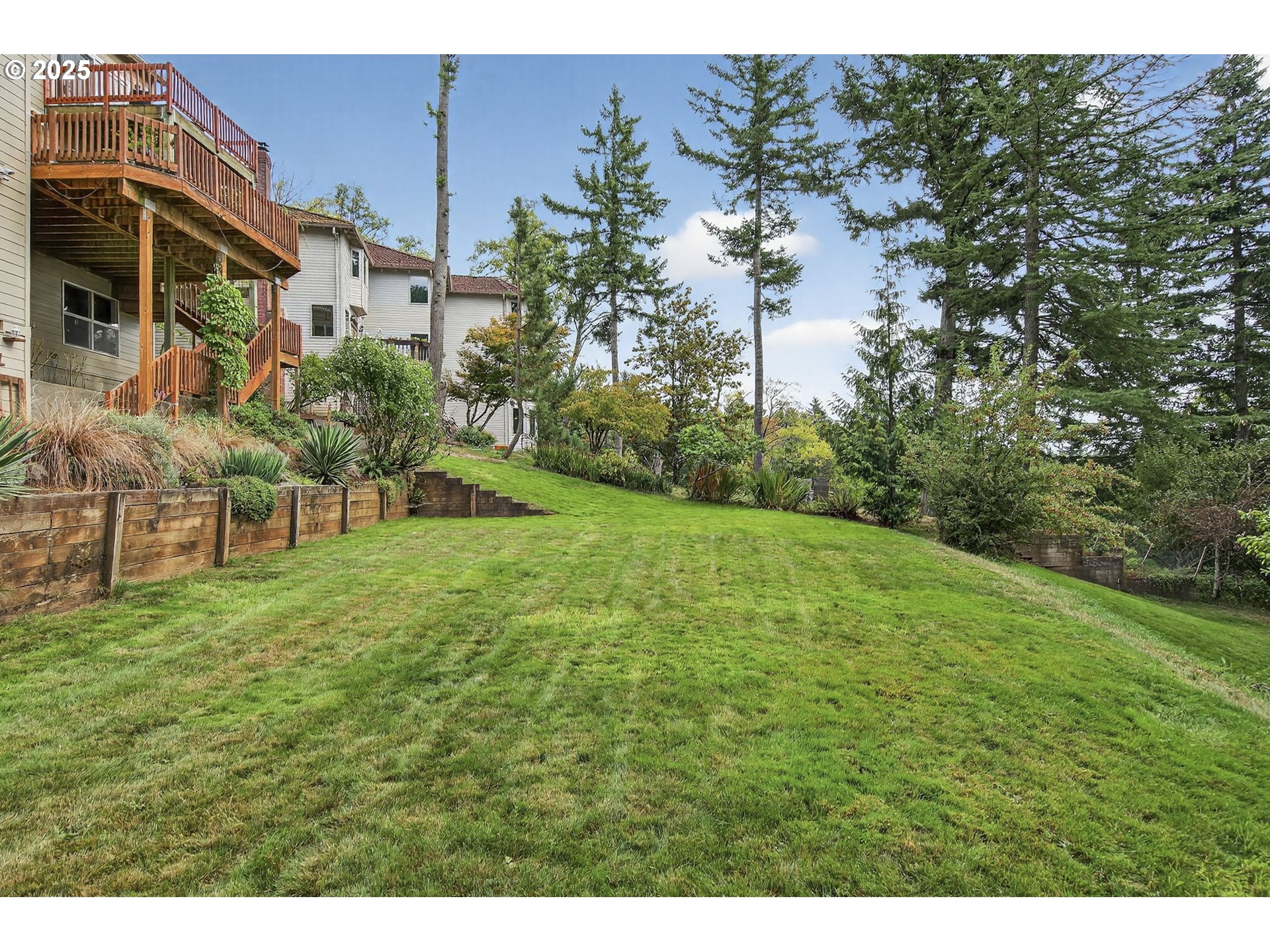 8452 Northwest Timber Ridge Court Portland, OR 97229 - Photo 47 of 48 a view of a yard with plants and a bench