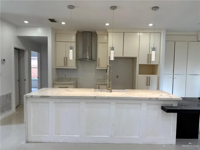 a kitchen with stainless steel appliances granite countertop a sink a stove a refrigerator and a oven