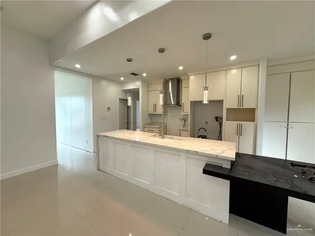 a large bathroom with a large tub and sink