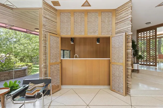 a view of a kitchen with a sink and large window
