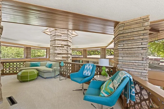 a bed sitting in a spacious bedroom next to a fireplace