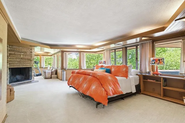 a bed room with bed and a large window