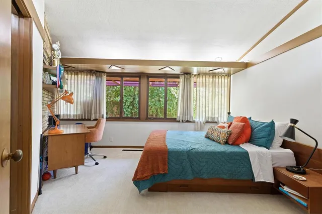 a bedroom with bed and a window