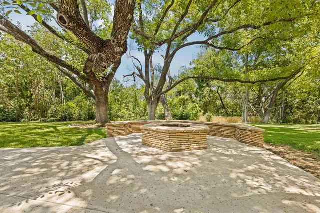 a view of a chairs and table in backyard